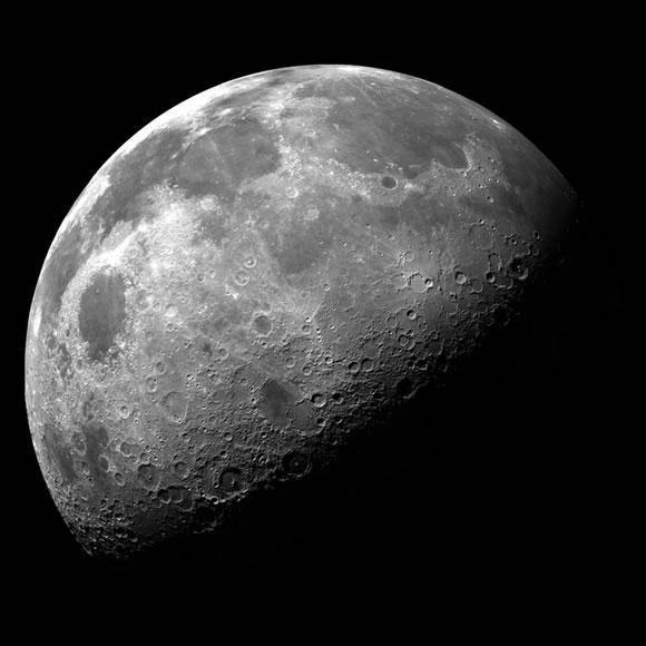Image of the moon, half-illuminated and half in darkness.