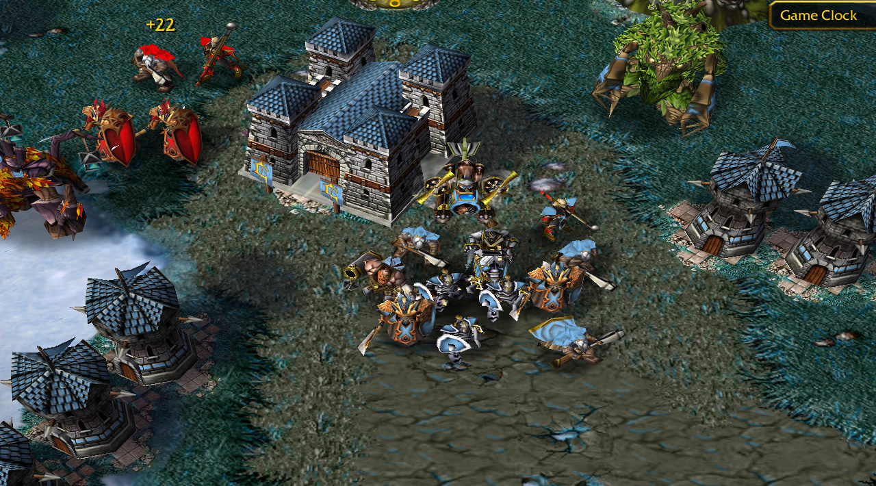 Four red units stand beside a light blue barracks, which has just spawned a large wave of light blue troops