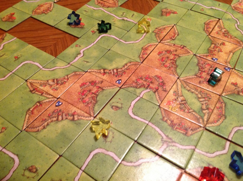 Picture of various board game tiles, connected to form a play area.